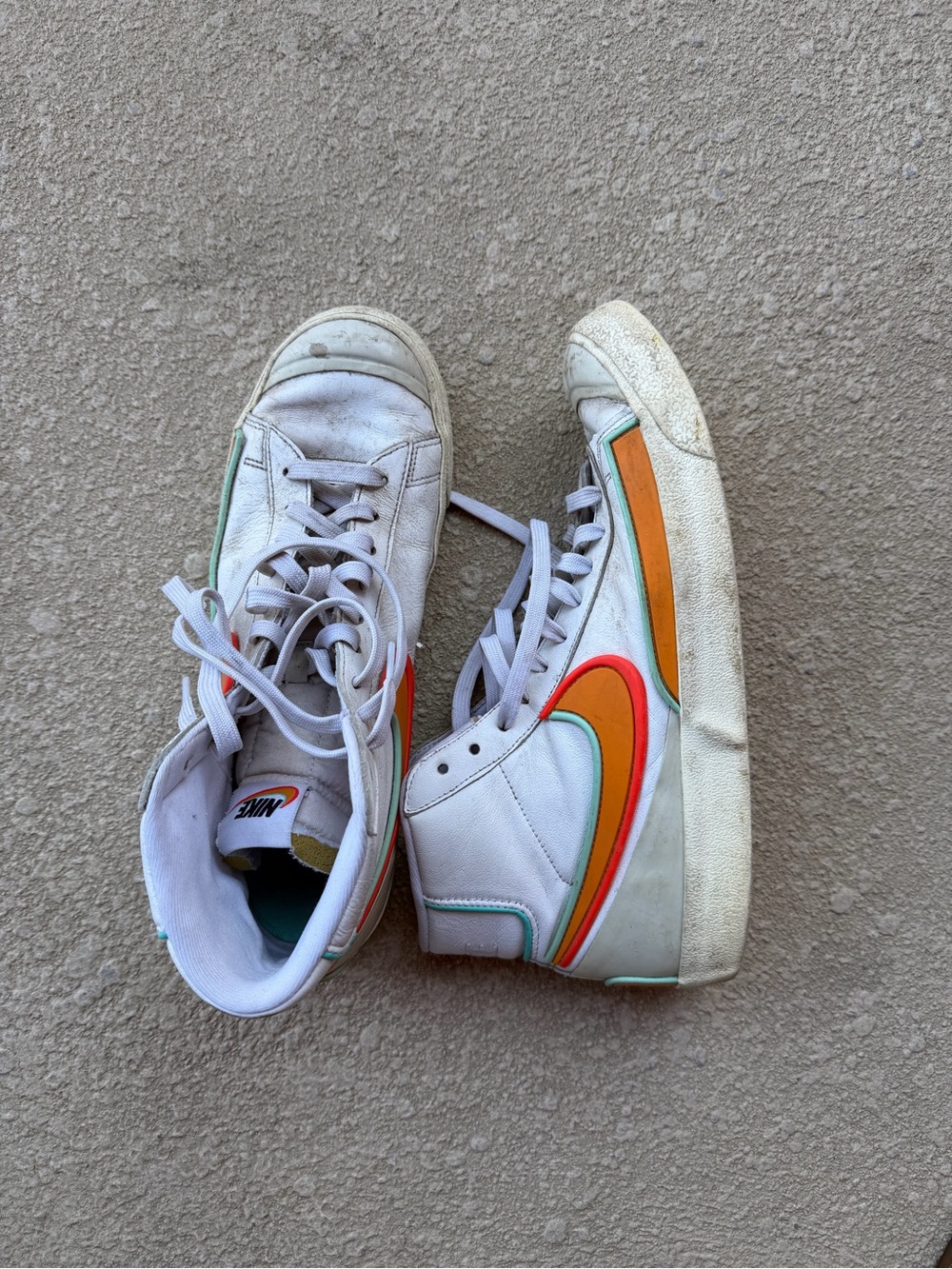 Nike White High-Top Sneakers with Orange and Red Swoosh